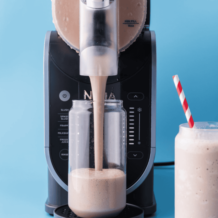 Ninja Slushi machine with a finished slush and two filled glasses beside it