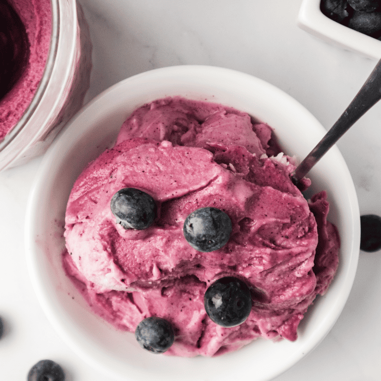 Swirl of blueberry frozen yogurt in a waffle cone made in the Ninja Creami