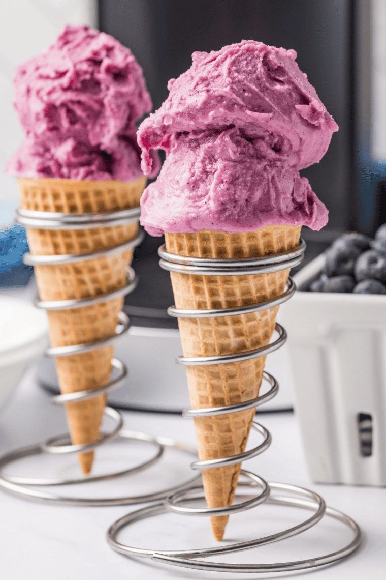 Swirl of blueberry frozen yogurt in a waffle cone made in the Ninja Creami