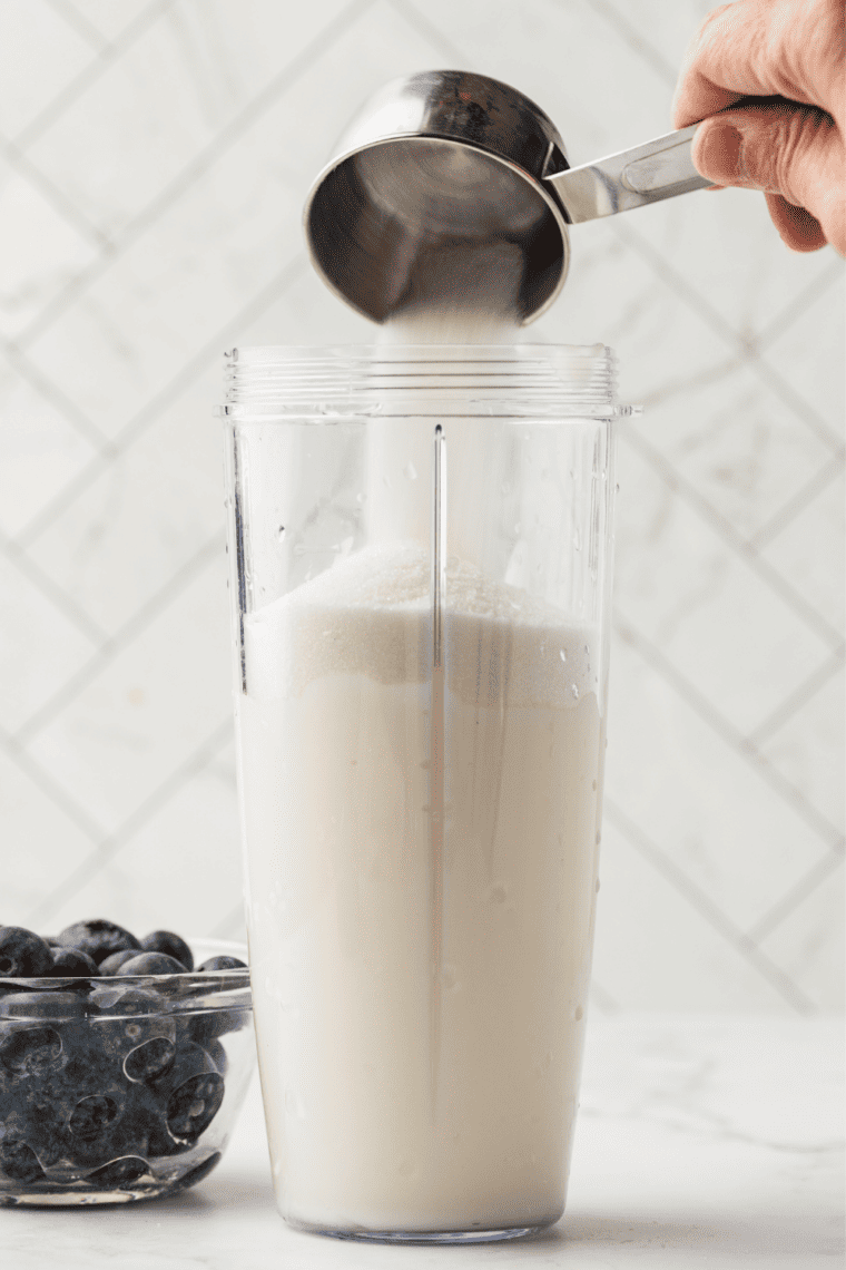 Blueberries, Greek yogurt, and sugar blended smooth and purple in a blender