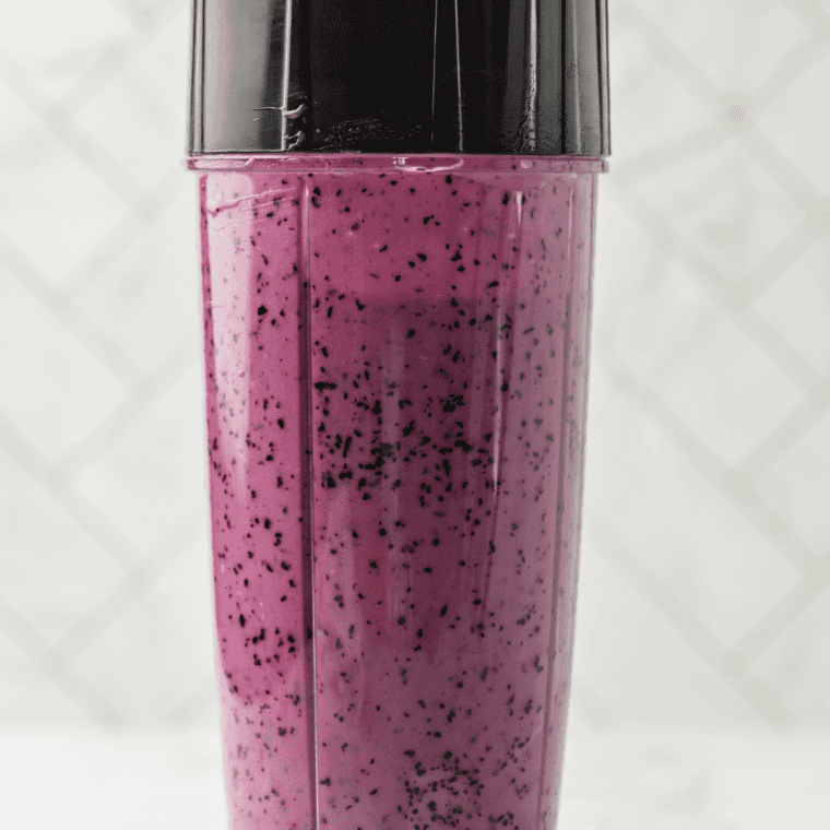 Leveled pint of blueberry frozen yogurt base freezing flat on a freezer shelf