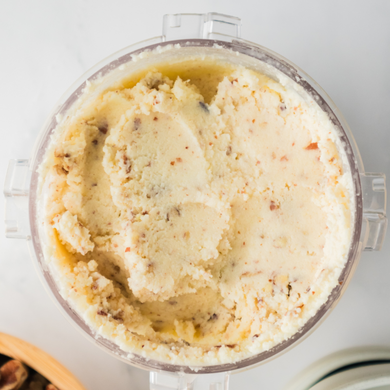 Toasted pecans in a well in the center of the pint before the Ninja Creami MIX-IN cycle