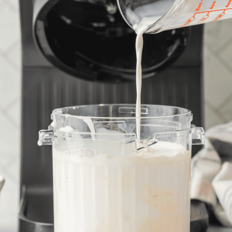 Stirring cheesecake filling and whole milk into vanilla ice cream until smooth in a Ninja Creami pint