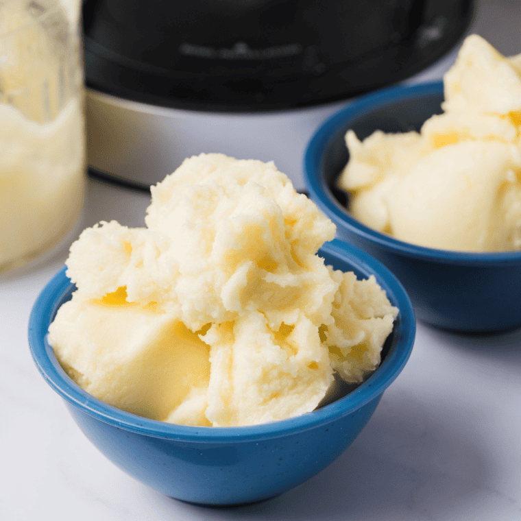 Ninja Creami Dole Whip swirled in a glass bowl, topped with a fresh pineapple wedge