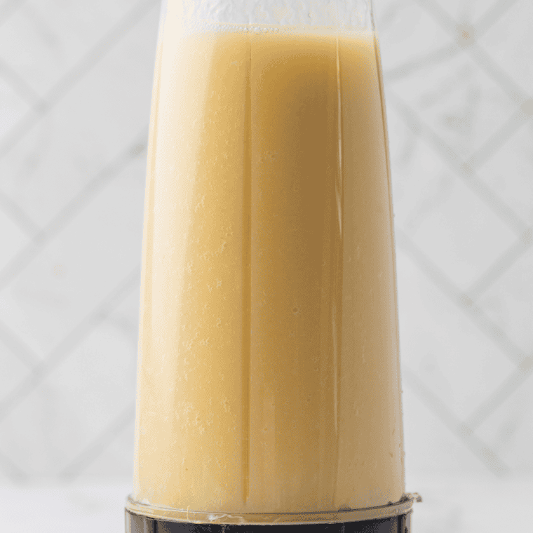 Pineapple chunks, juice, milk, vanilla ice cream mix, and sugar blended smooth in a blender for Ninja Creami Dole Whi