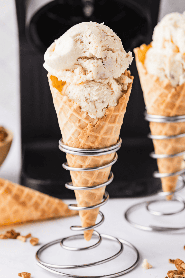 Ninja Creami gooey butter cake ice cream in a waffle cone with visible cake crumbles and a buttery swirl