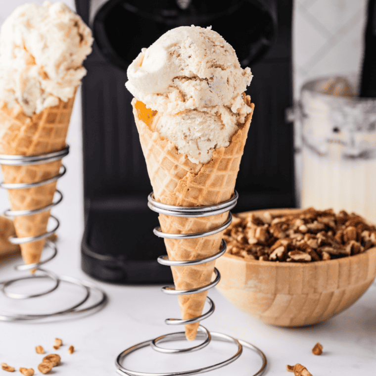 Ninja Creami gooey butter cake ice cream in a cake cone held against a plain background