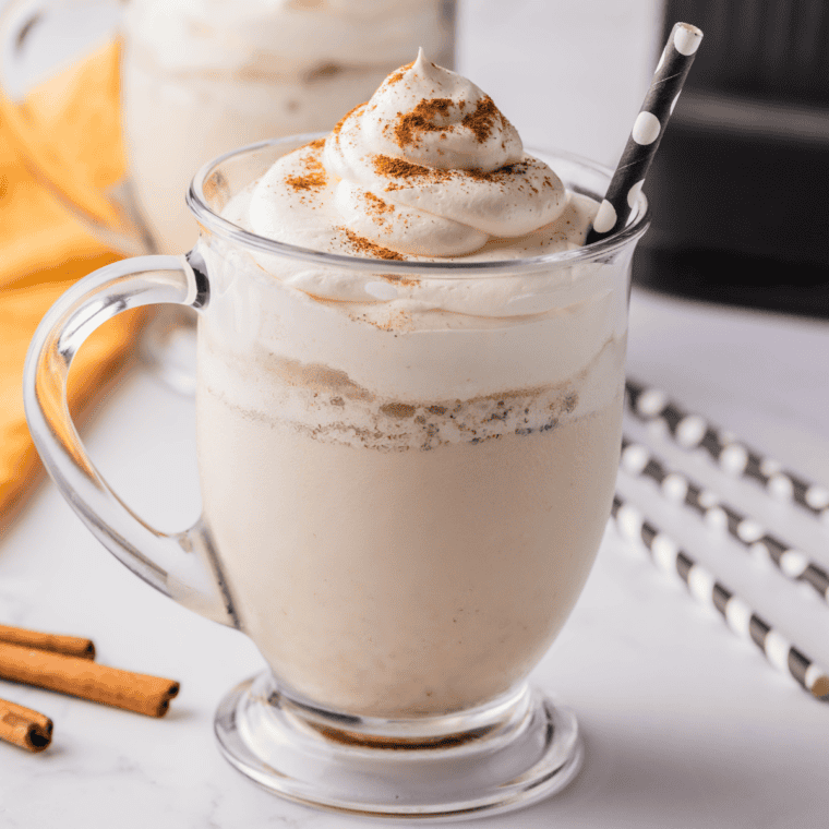 Pumpkin pie Blizzard in a cup topped with whipped cream and nutmeg, pie crust pieces visible throughout