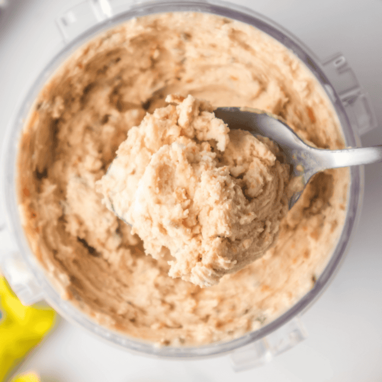 Pumpkin pie Blizzard in a cup topped with whipped cream and nutmeg, pie crust pieces visible throughout