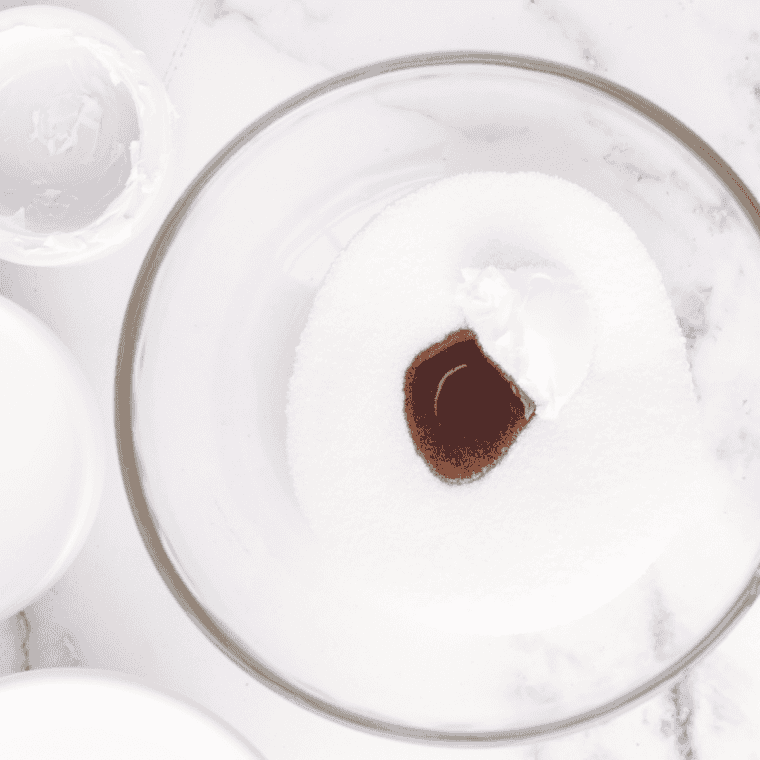Cream cheese, sugar, cream, milk, and vanilla whisked smooth in a glass mixing bowl