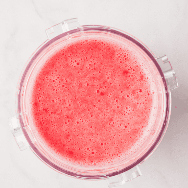 Raspberries, sugar, and lemonade blended smooth in a blender