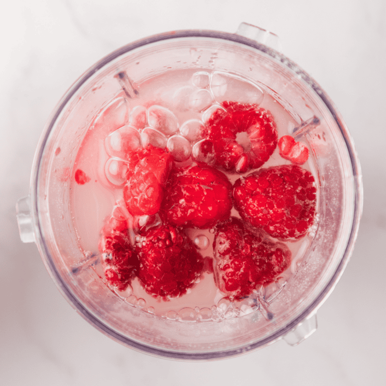 Lemonade poured into a measuring cup for Ninja Creami sorbet