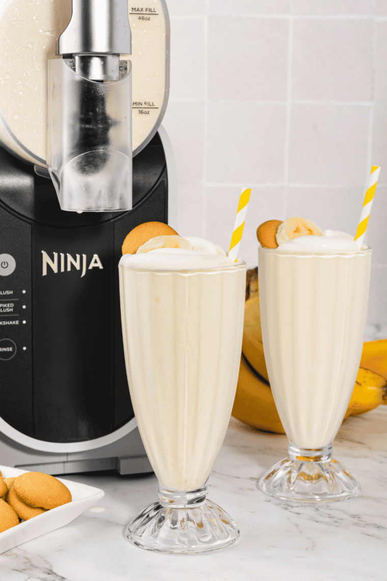 Thick Ninja Creami Steak 'n Shake banana shake in a tall glass topped with whipped cream and a maraschino cherry