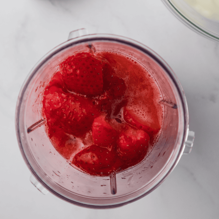 Fresh strawberries macerating in honey and releasing a red syrup