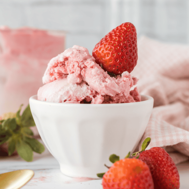 Spoon in a bowl of creamy Ninja Creami strawberry ice cream