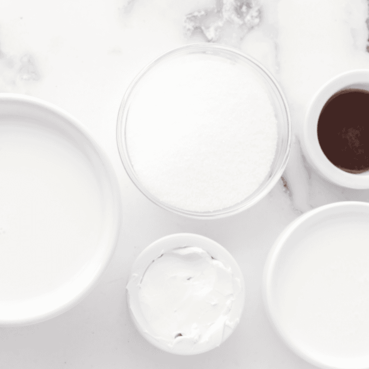 Greek yogurt, milk, honey, vanilla bean, and salt in bowls on a counter 