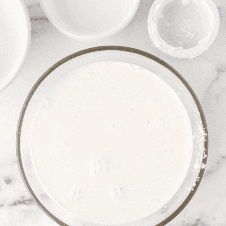 Milk, honey, vanilla bean seeds, and salt whisked together in a glass bowl