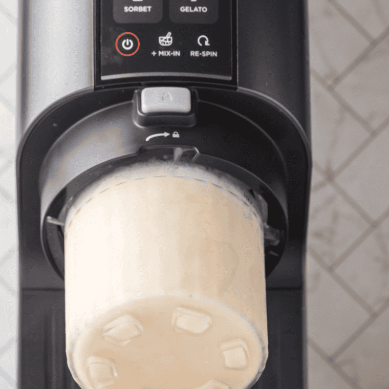 Ninja Creami ice cream maker with a pint container of freshly spun vanilla ice cream