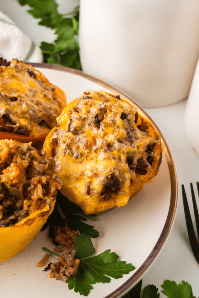 Ninja Crispi stuffed peppers filled with seasoned beef and Spanish rice under golden melted cheese