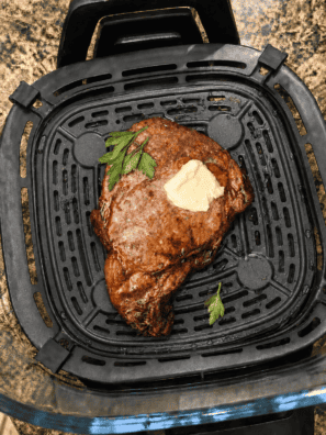 Seared steak bites in the Ninja Crispi glass container on the crisper plate