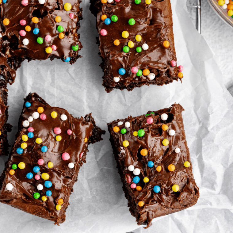Brownies on a white plate, cut into squares with fudgy centers