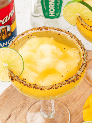 Ninja Slushi dispensing a frozen lime margarita into a salt-rimmed glass