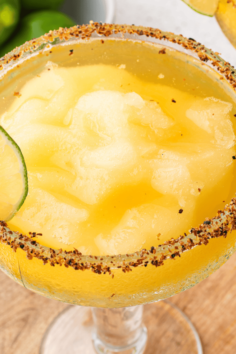 Glass rim dipped in kosher salt before dispensing the frozen lime margarita