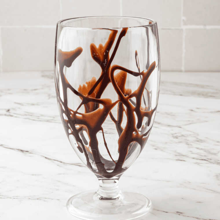Frozen mudslide dispensing from the Ninja Slushi tap into a chilled glass