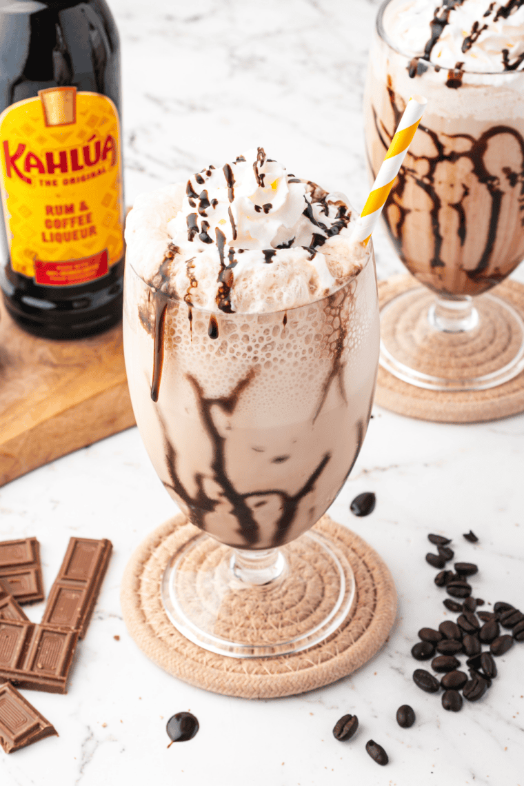 Hand pulling the Ninja Slushi tap handle to dispense a frozen mudslide