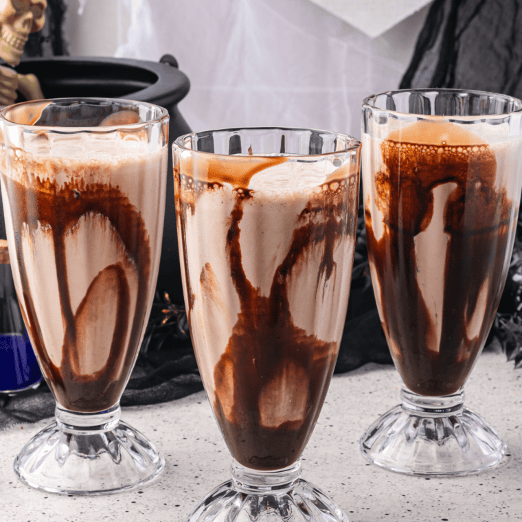 Small pour of Oreo milkshake dispensed into a glass to check thickness