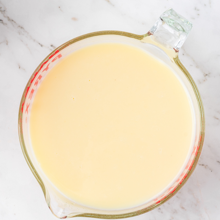 Vanilla Frosty mixture whisked smooth in a glass measuring cup before pouring into the Ninja Slushi
