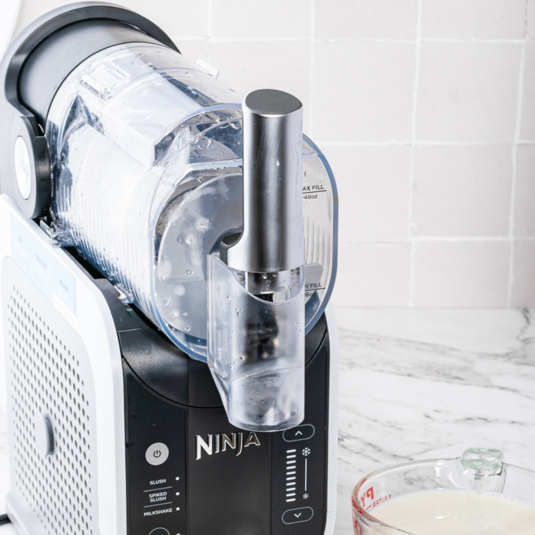 Vanilla Frosty mixture being poured into the Ninja Slushi machine below the max fill line