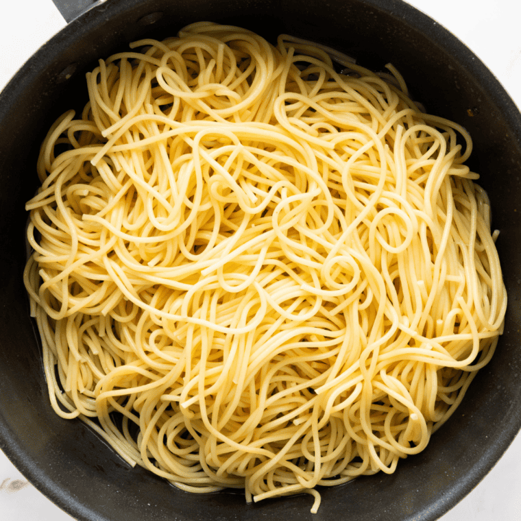 Cooked spaghetti draining in a colander