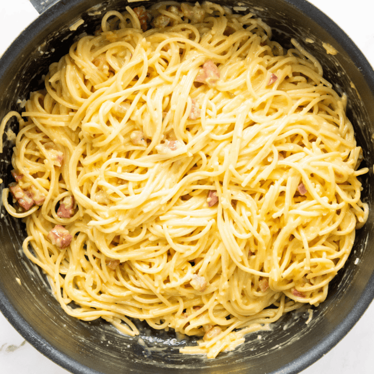 Browned butter poured over hot spaghetti in a pot