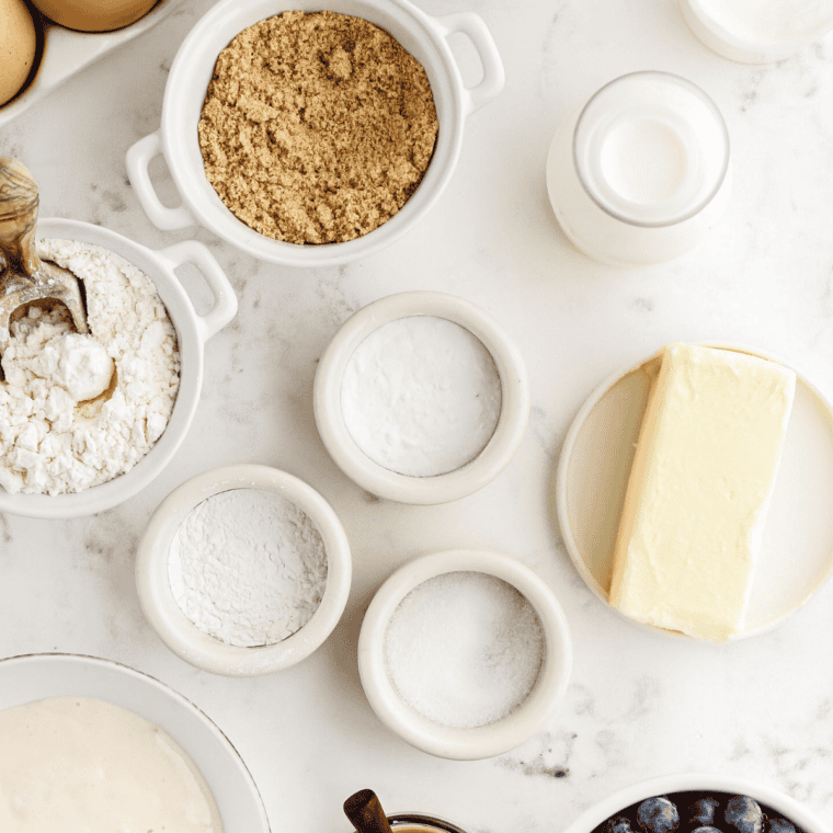 Flour, sugar, sour cream, eggs, butter and fresh blueberries measured for Mammoth Muffins
