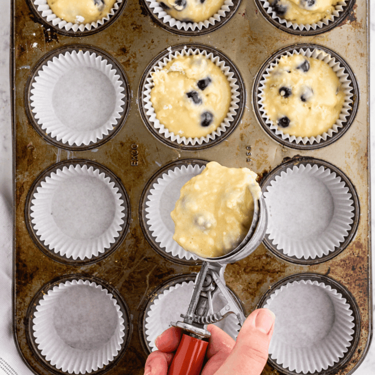 Jumbo muffin cups filled to the rim and mounded with streusel crumbs