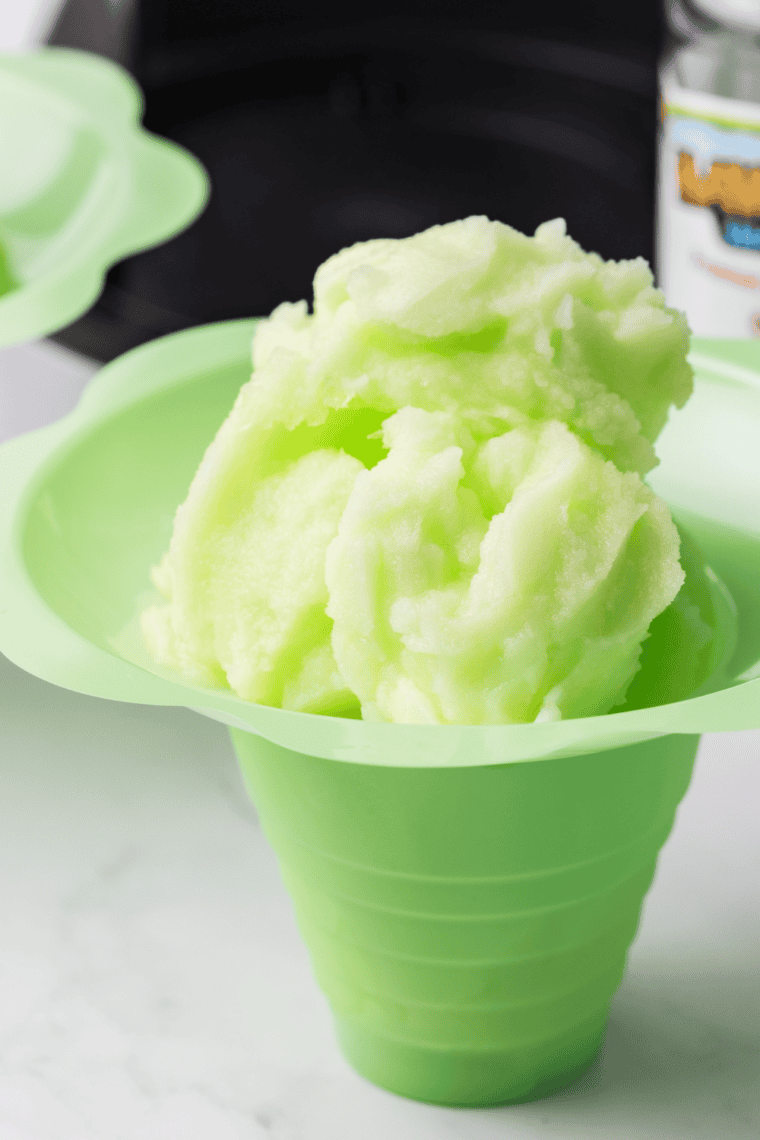 Sugar-free Ninja Creami Italian ice in a bowl with a lemon slice on top