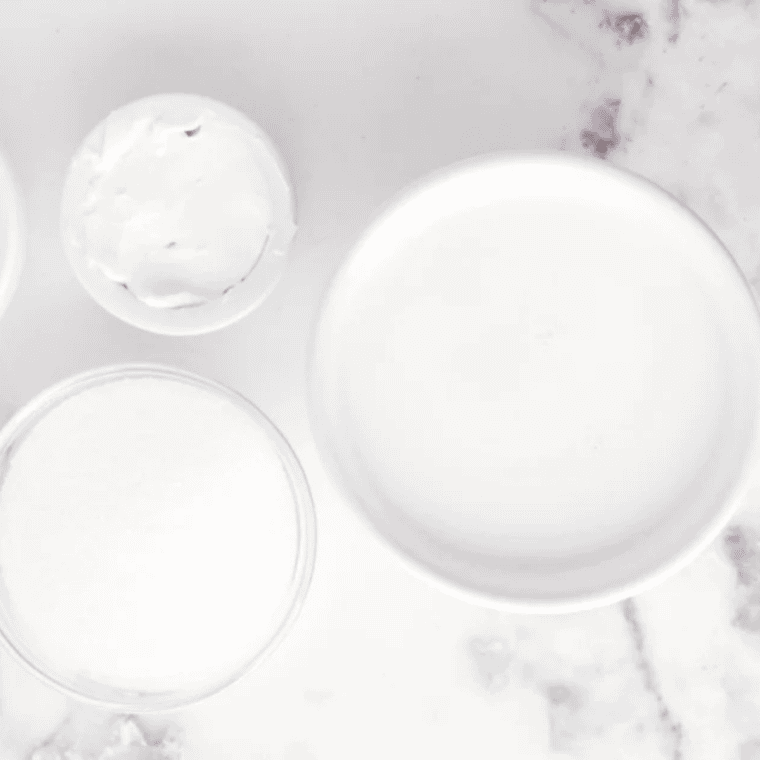Protein powder, Greek yogurt, milk, allulose, vanilla, and salt in small bowls