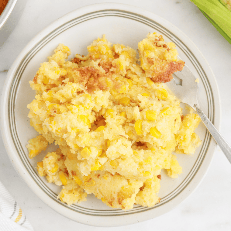 Bowl of creamy copycat 12 Bones Smokehouse corn pudding ready to serve