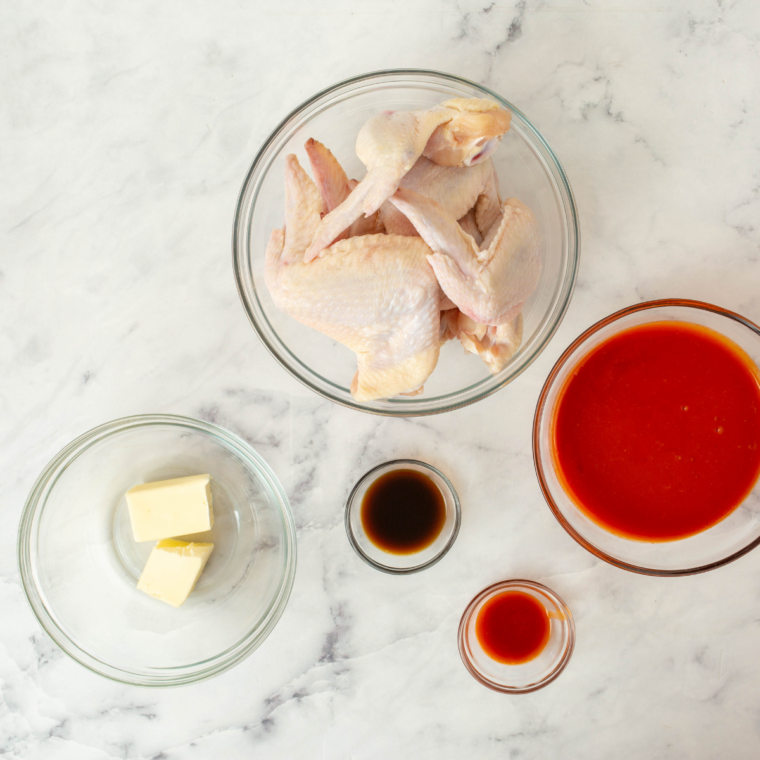 Ingredients for Buc-ee's BBQ wings including chicken wings, baking powder, spices, and BBQ sauce
