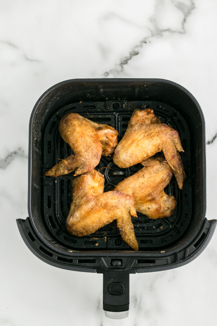Golden crispy air fryer chicken wings before saucing