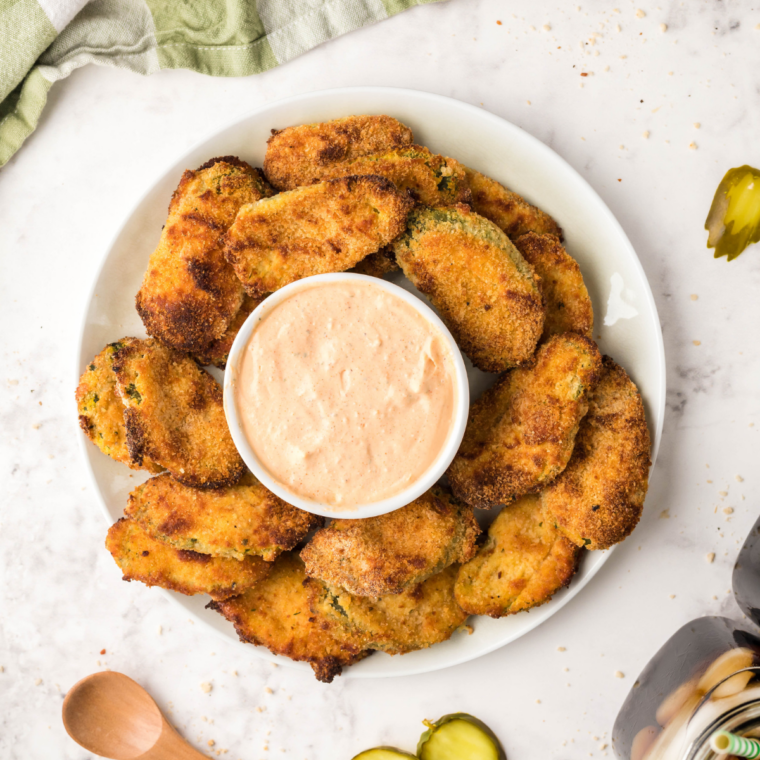 crispy air fryer Culver's fried pickles sprinkled with salt and served with dipping sauce