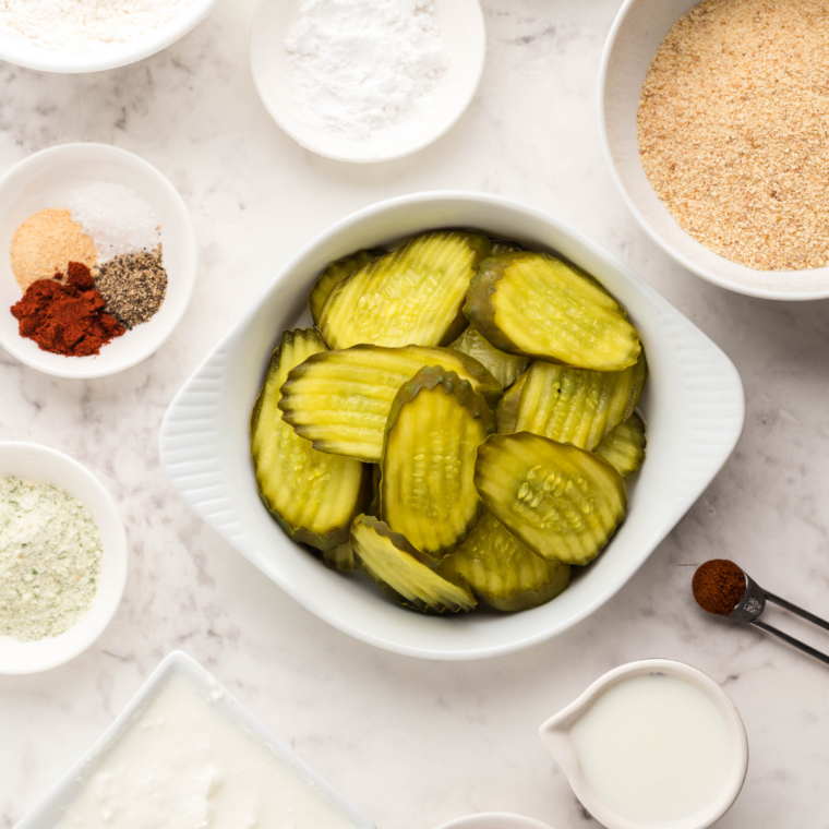 Ingredients for copycat Culver's fried pickles, including dill pickle chips, flour, cornstarch, eggs, buttermilk, panko, and seasonings