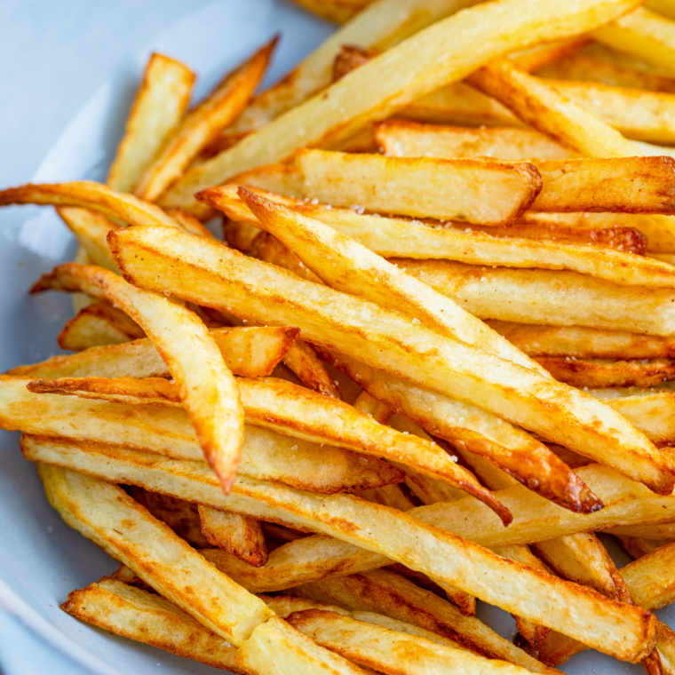 Overhead shot of crispy golden Air Fryer Steak 'n Shake copycat fries served in a red basket