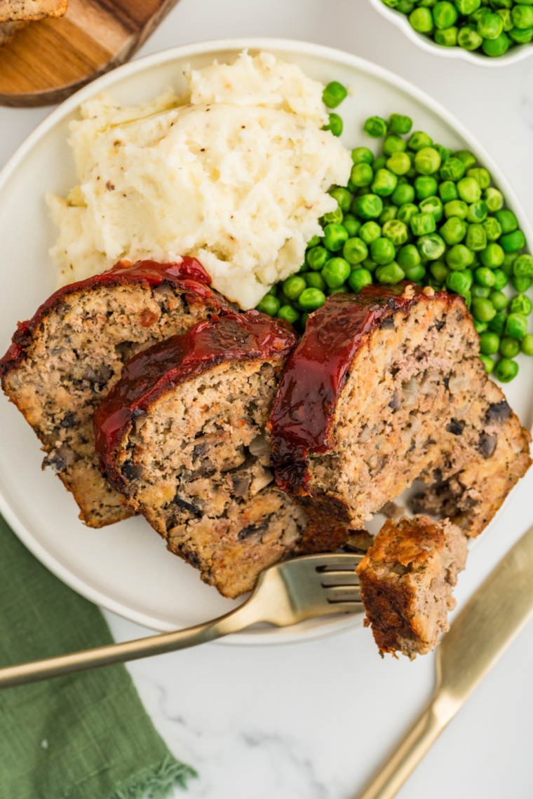 Copycat Bob Evans meatloaf with signature glaze sliced on a cutting board