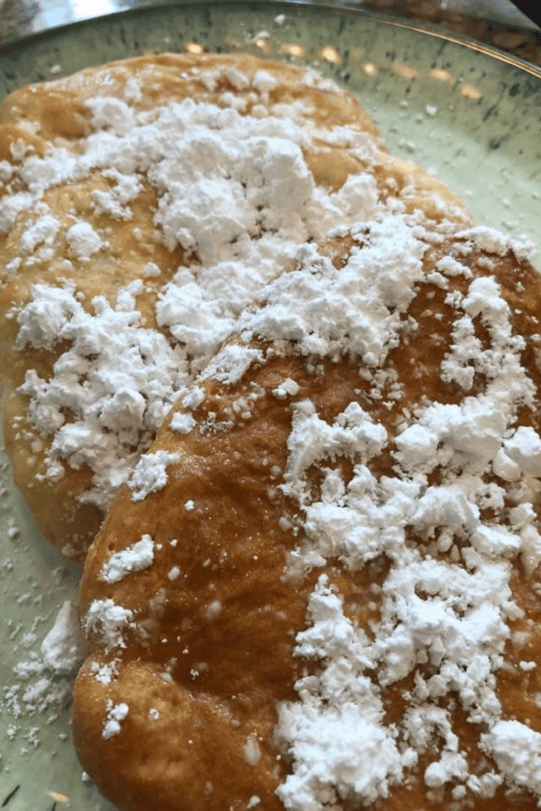 Homemade Buc-ee's Beaver Tail copycat with icing drizzle served on a green plate