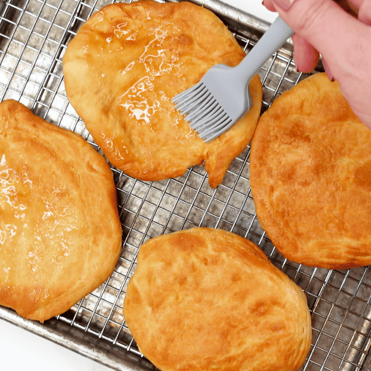 Brushing melted butter over a baked Buc-ee's Beaver Tail copycat