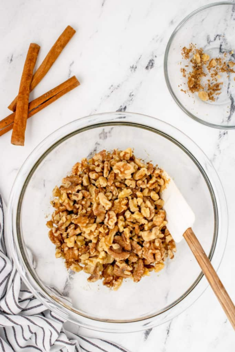 Small bowl of granulated sugar, brown sugar, cinnamon, and salt stirred together for candied nuts