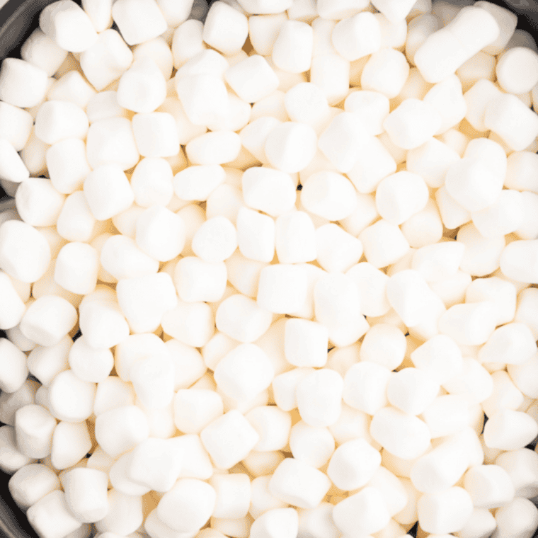 Whole mini marshmallows folded into coated Fruity Pebbles cereal mixture