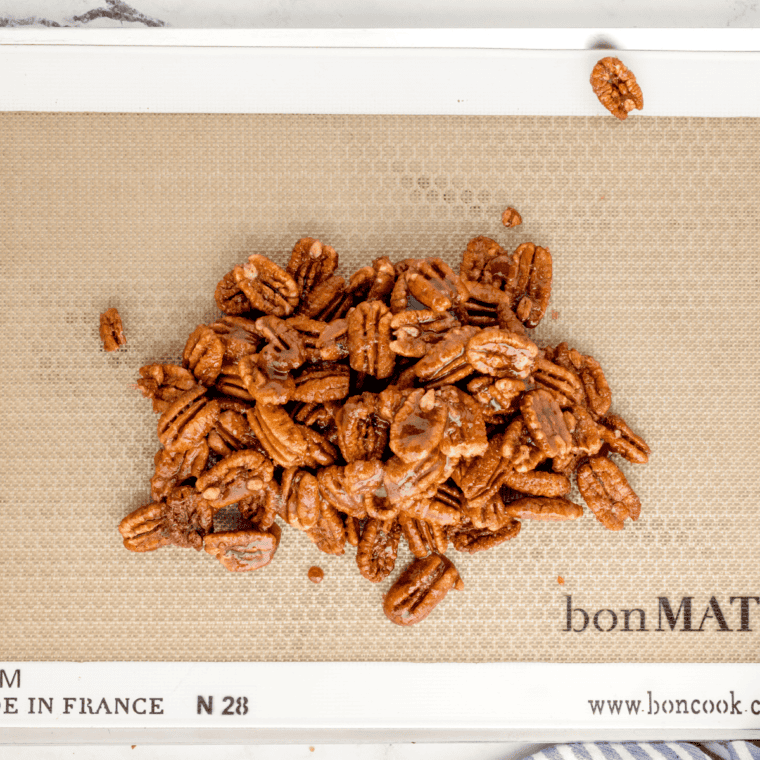 Toasted pecan halves on a baking sheet for homemade pecan pralines